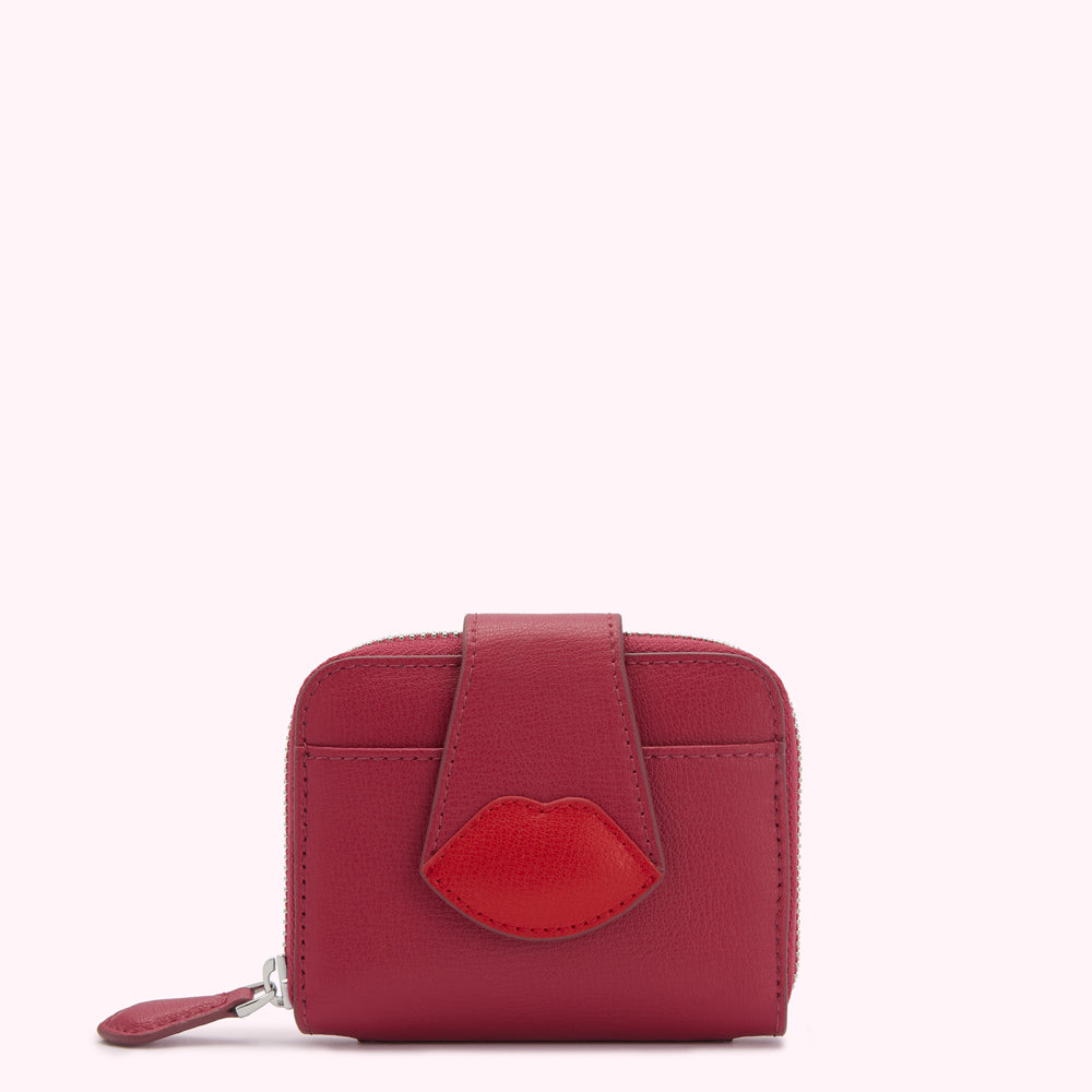 Red leather wallet with a red lip detail on a white background.