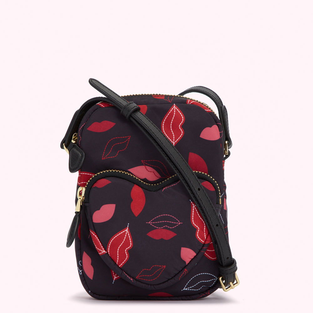 Black crossbody bag with a heart-shaped front pocket and a lip print.