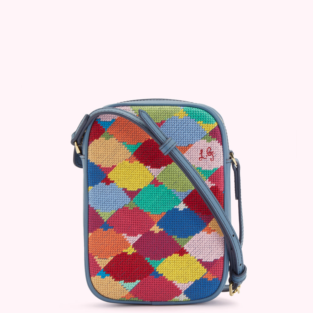 Multi-coloured needlepoint crossbody bag with blue leather trim and strap.