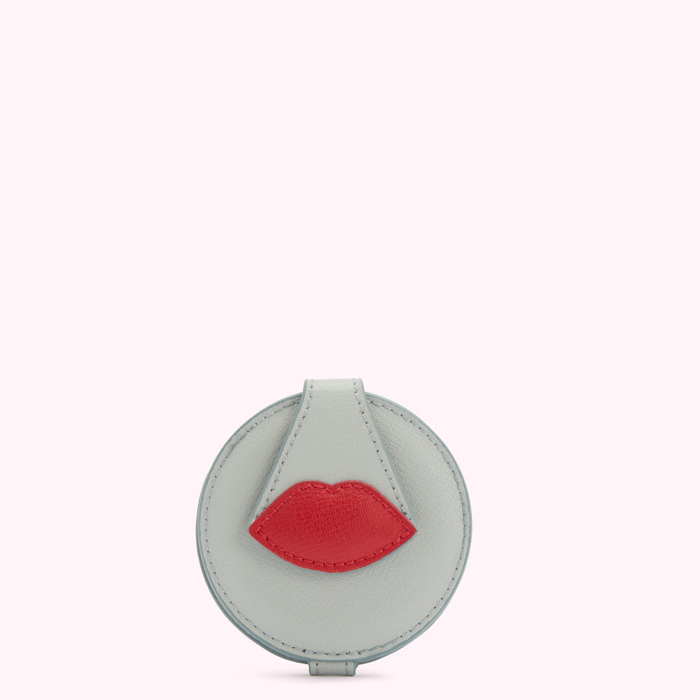 Light blue circular compact mirror with a red lip detail.