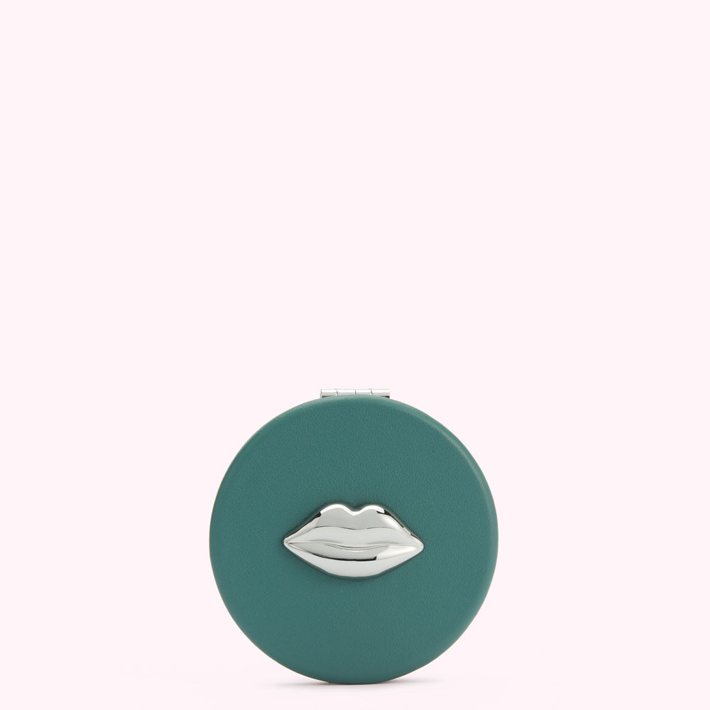 Teal round compact mirror with silver lip design.