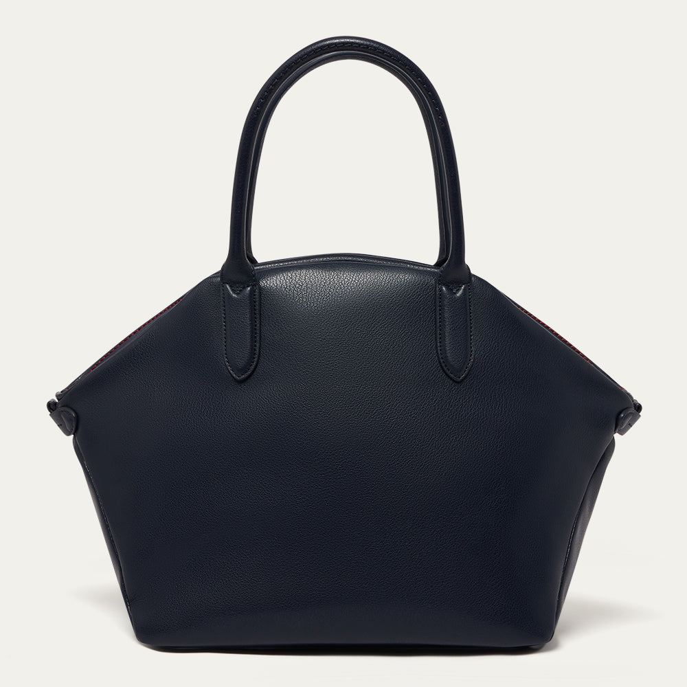 Navy blue leather tote bag on a light gray background