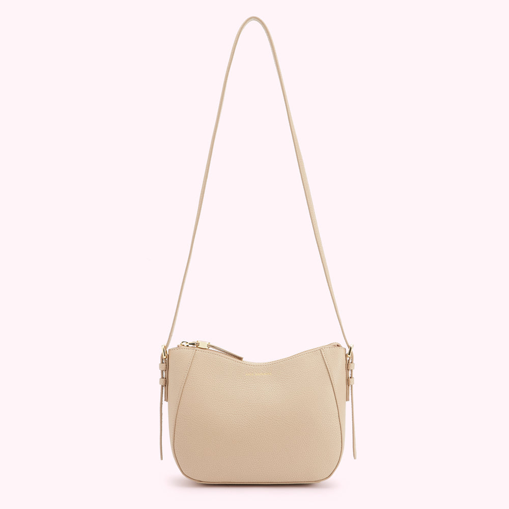 Beige crossbody bag with long strap and gold zipper.