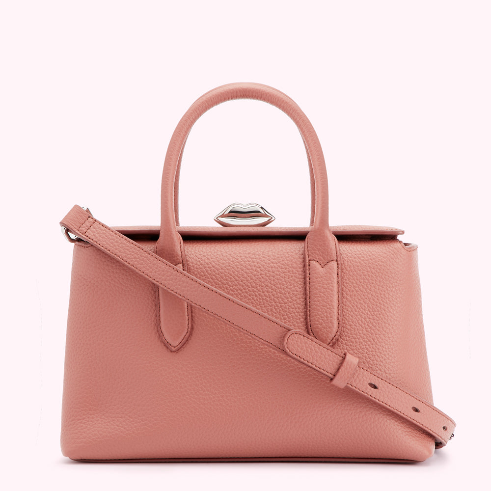 A dusty rose-coloured leather handbag with a silver lip-shaped clasp.