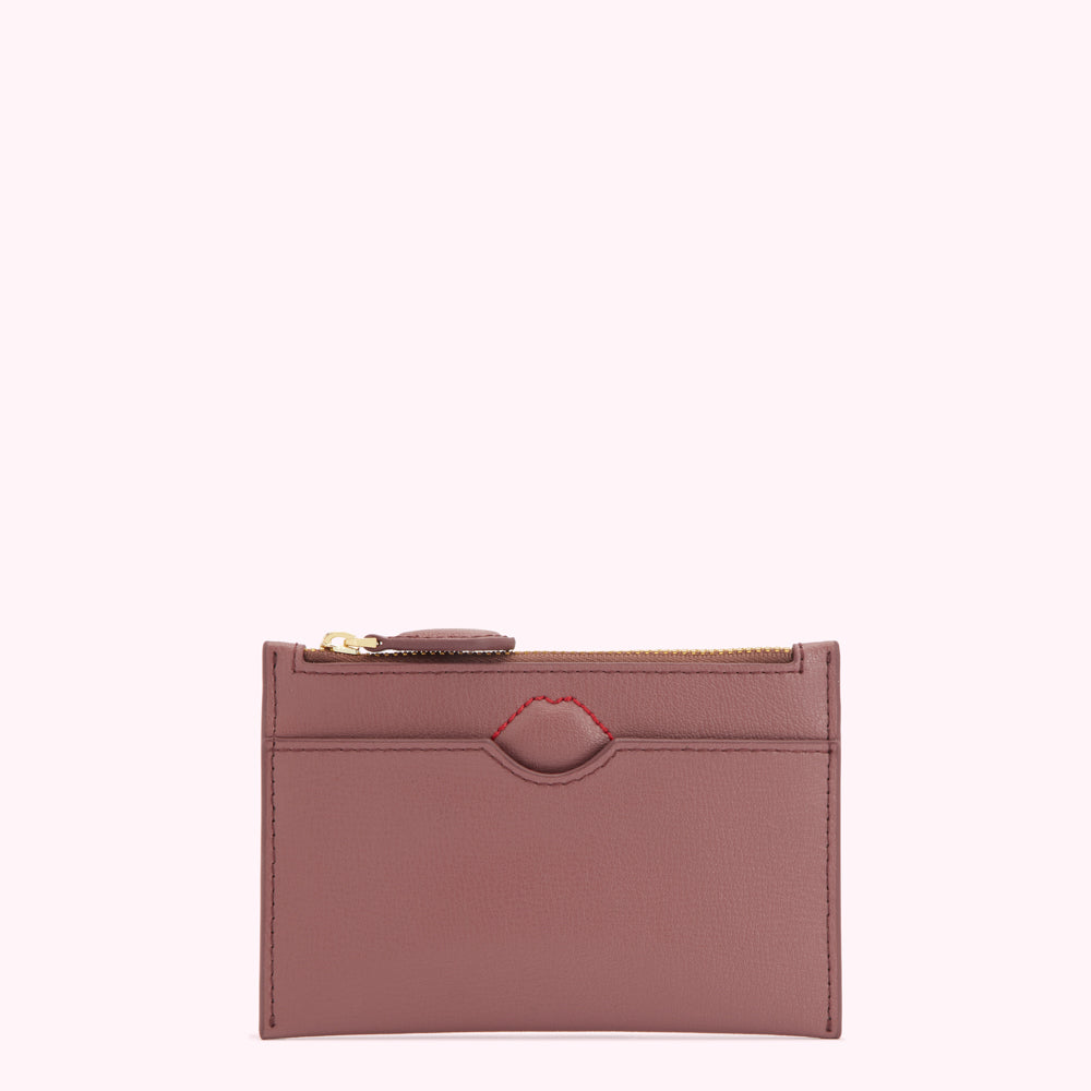 Dusty rose leather zip-around cardholder with a red lip detail.