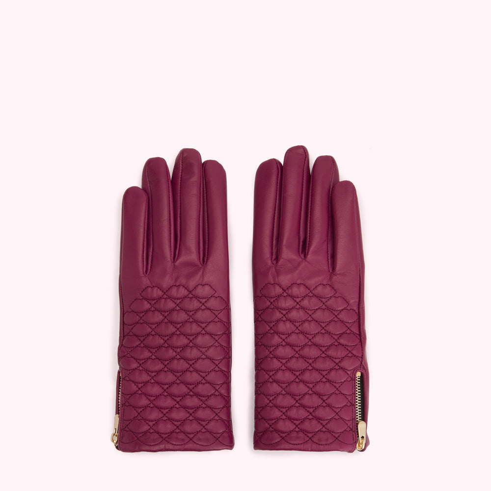 Pair of quilted purple leather gloves with gold zippers.