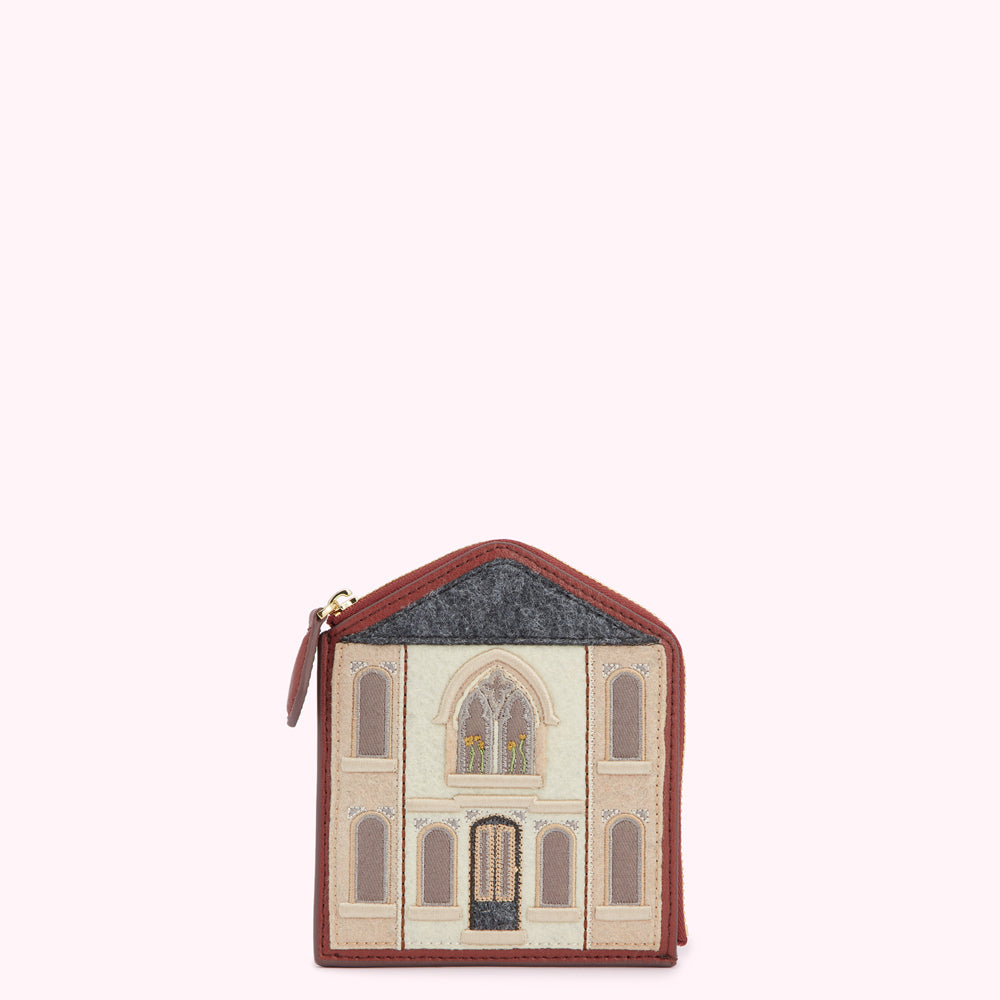 Brown leather purse shaped like a house with embroidered details.