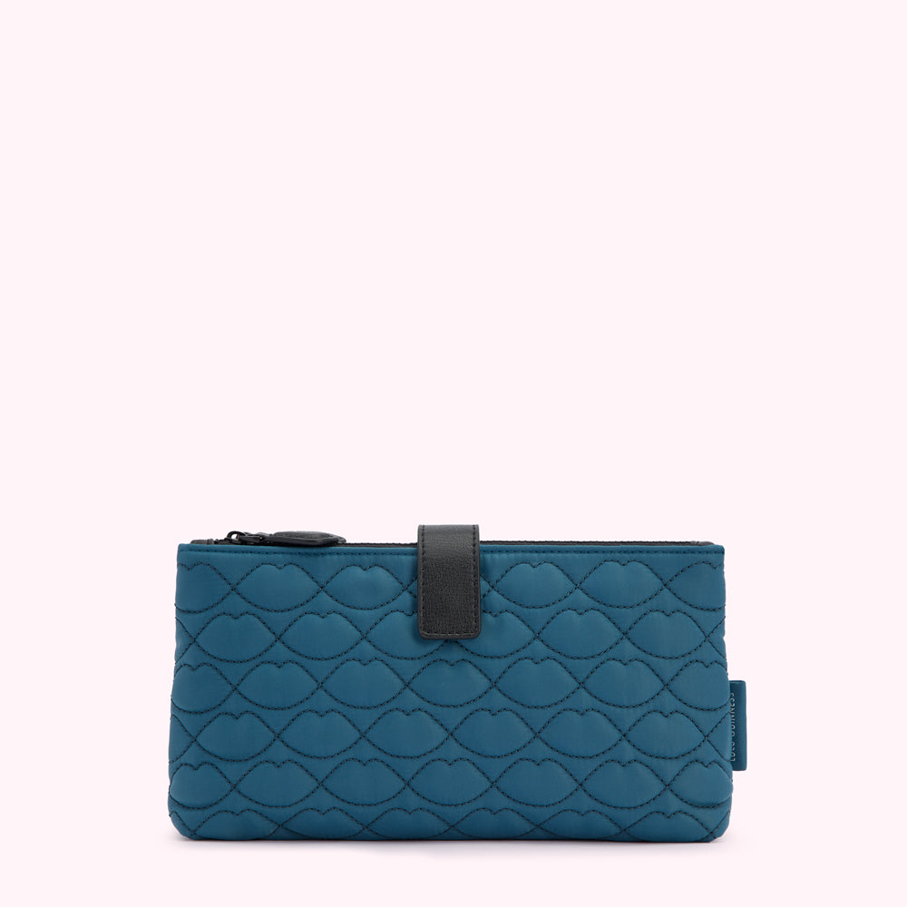 Teal quilted makeup bag with black zipper and tab, featuring a lip print pattern.
