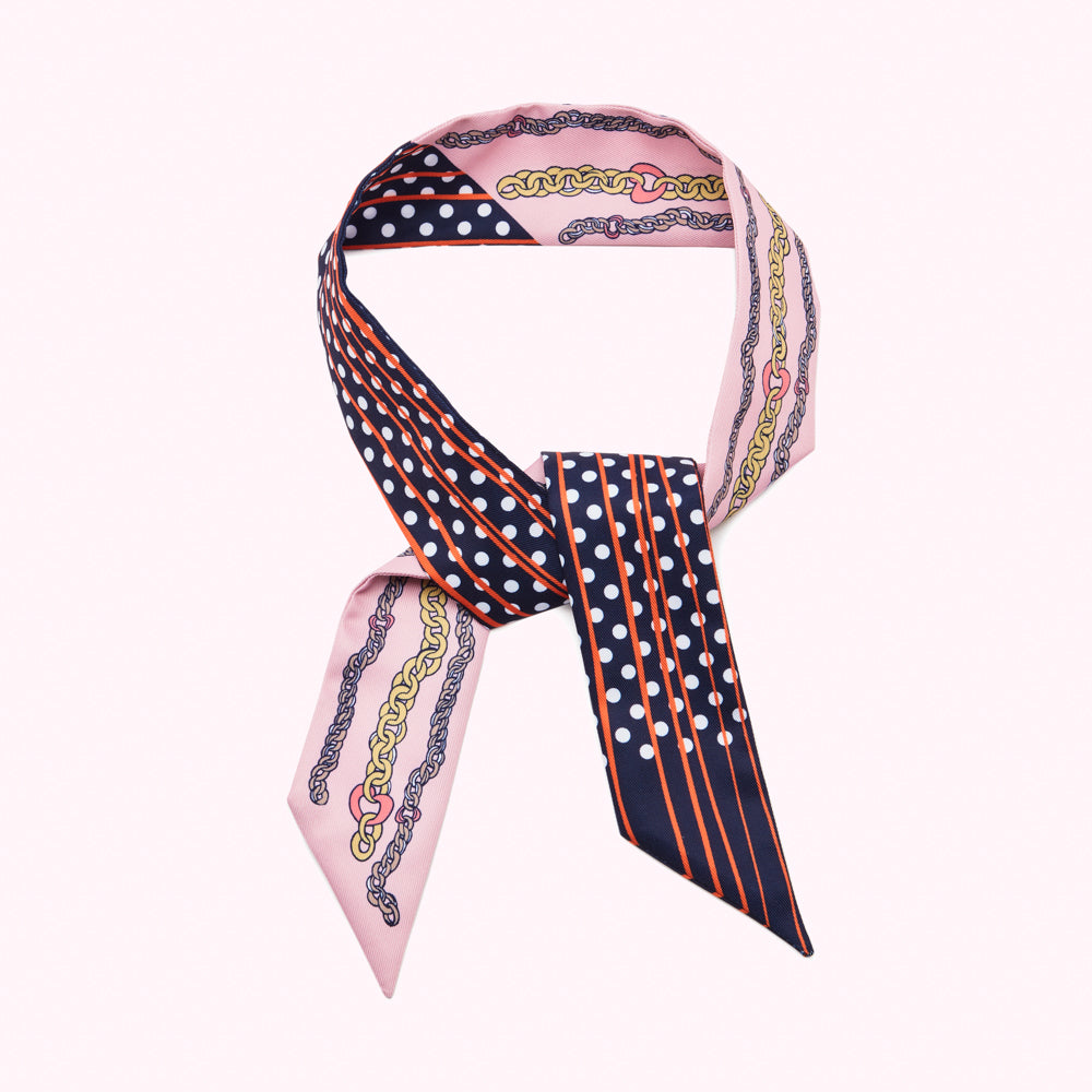 Pink and navy silk scarf with gold chain and polka dot print.