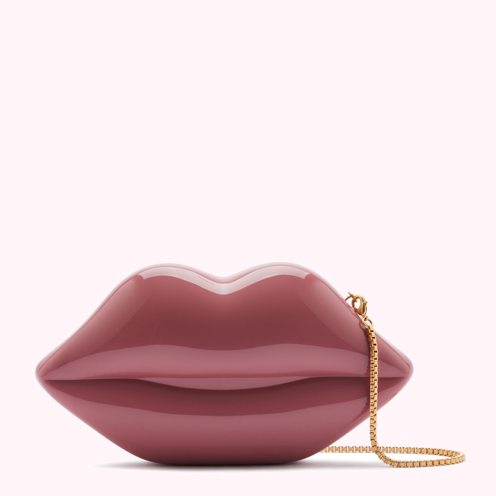 Dusty rose lip-shaped clutch with gold chain strap.