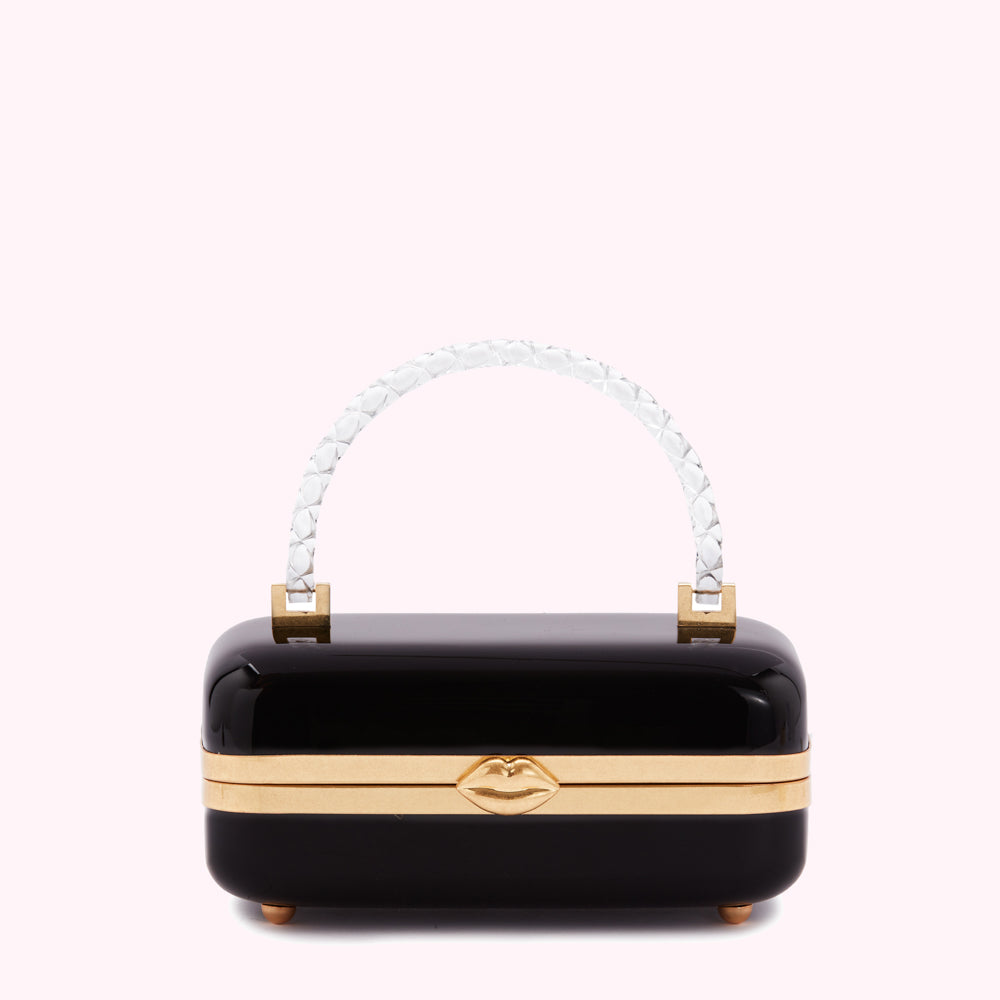 Black rectangular box handbag with a clear handle and gold lip detail.