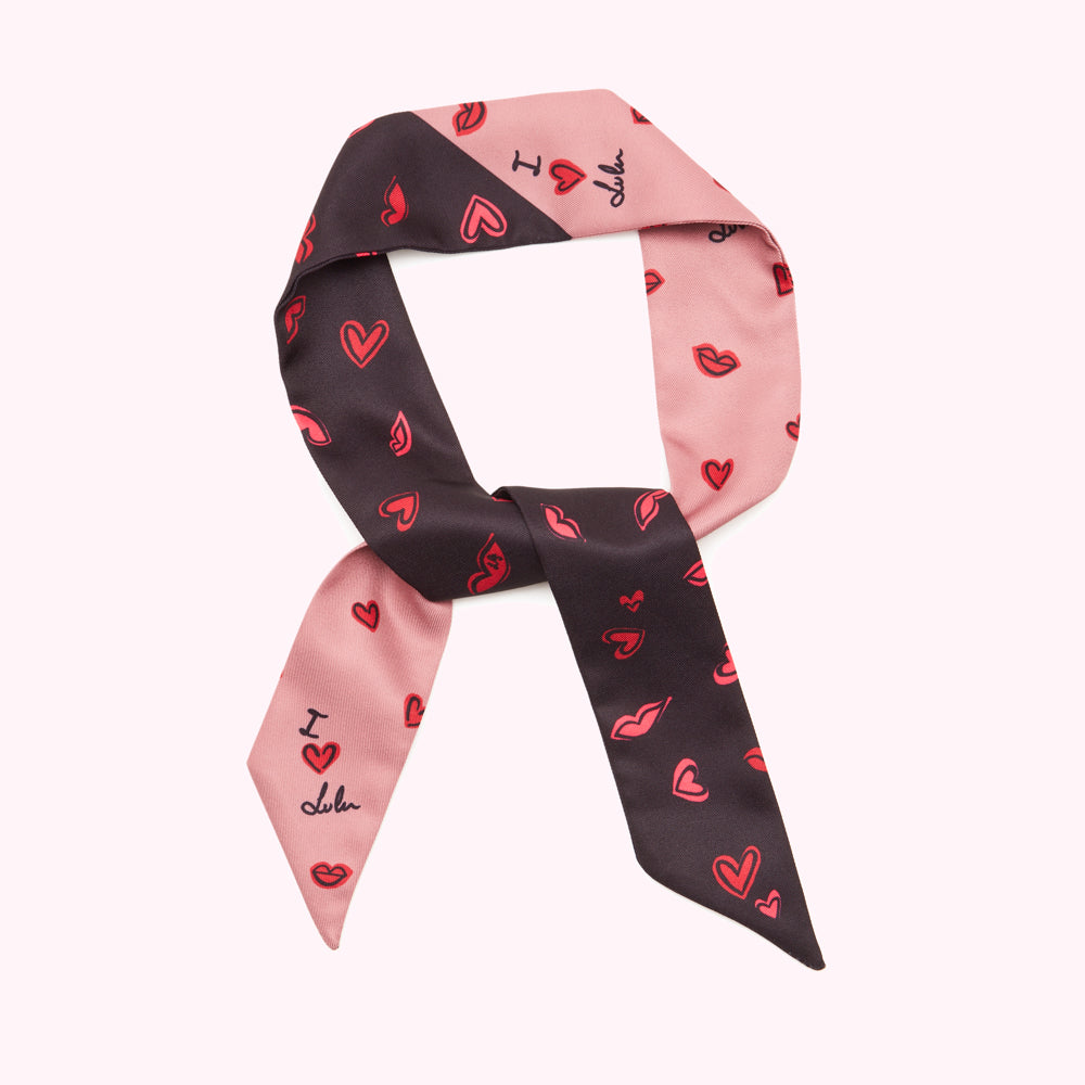 Pink and black silk scarf with a pattern of red hearts and lips; the text "I love Lulu" is printed on the scarf.