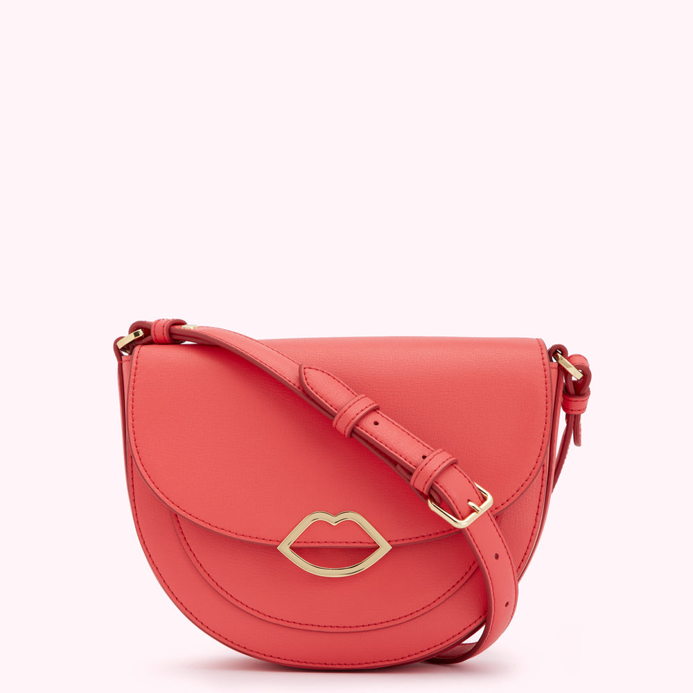 Coral-coloured half-moon crossbody bag with gold lip detail.