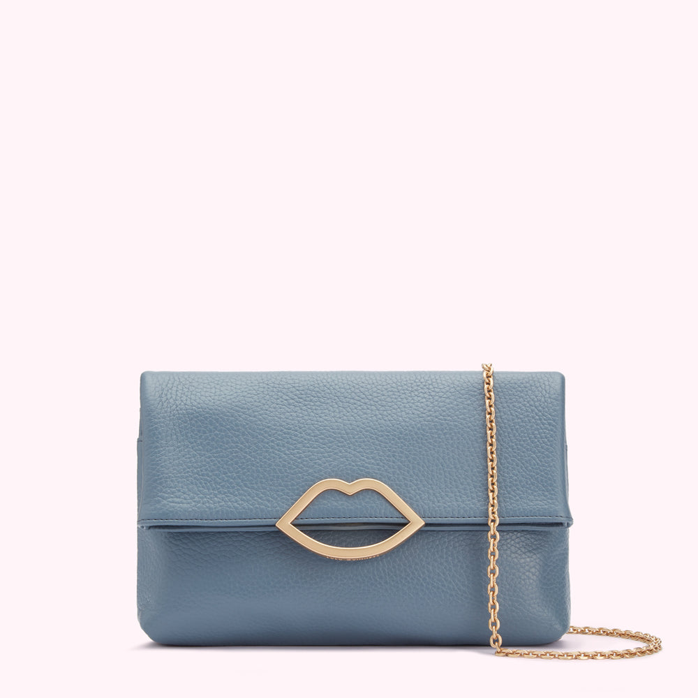 Dusty blue leather clutch with gold lip-shaped closure and gold chain strap.