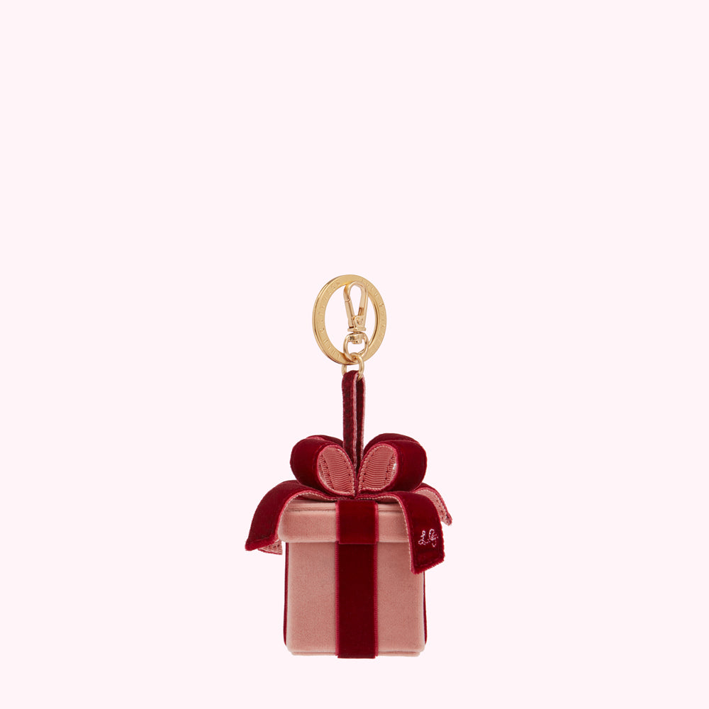 Pink velvet gift box-shaped keychain with a burgundy velvet bow and gold clasp.