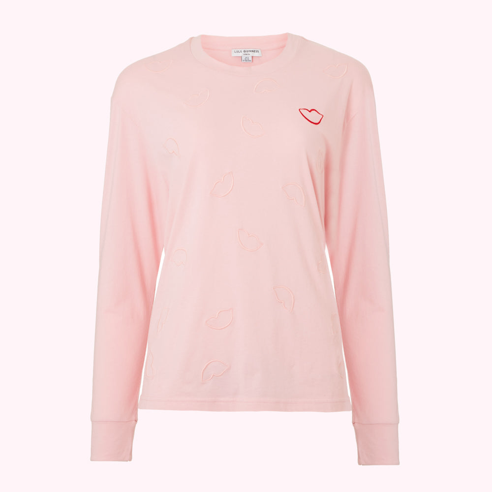 Pink long-sleeve shirt with embroidered lips.