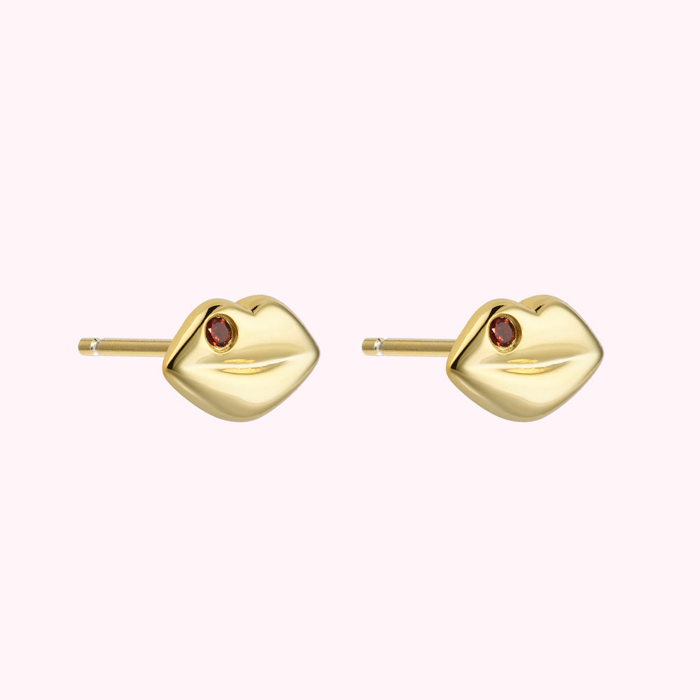 Side image of 14k gold plated sterling silver lip shaped stud earring with inset Ruby previous stones.