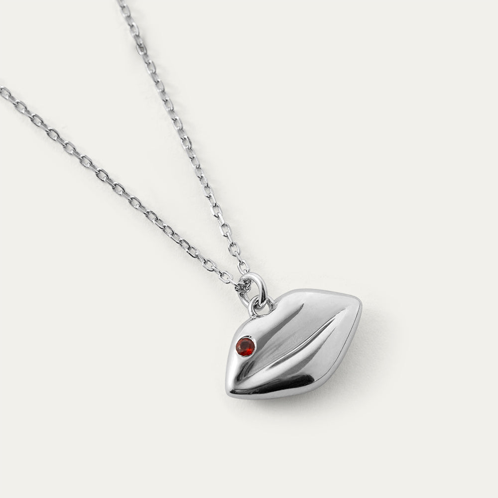 Silver necklace with a lip-shaped pendant on a white background