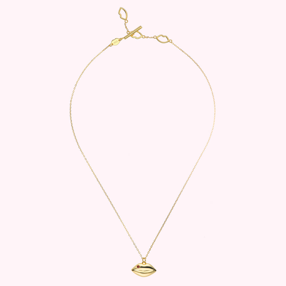 14K gold plated sterling silver necklace with solid lip pendant charm featuring a inset Ruby precious stone.
