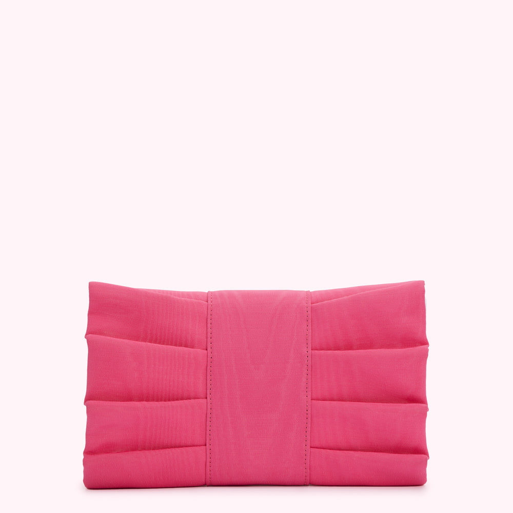 Pink pleated clutch purse against a white background.
