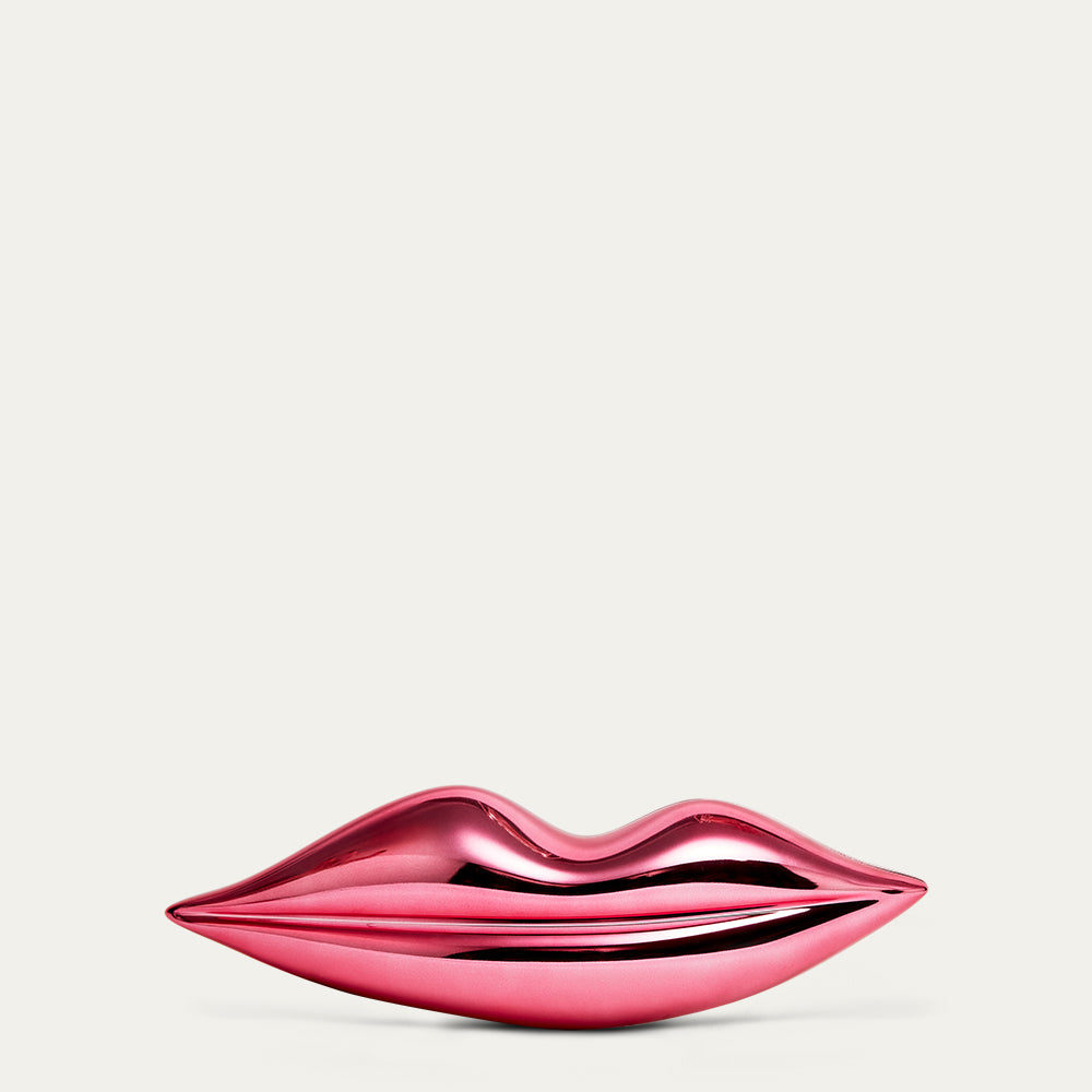 Pink glossy lip clutch on a light pink background
