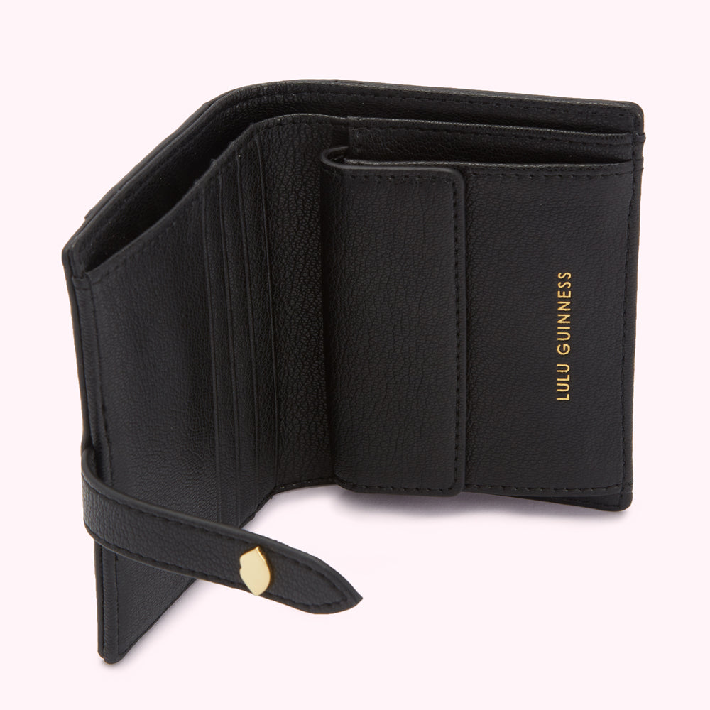 Open black Lulu Guinness leather wallet with gold clasp.
