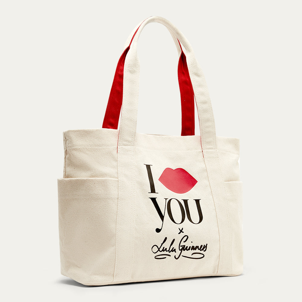 Beige tote bag with red interior, 'I Lip You x Lulu Guinness' text,
