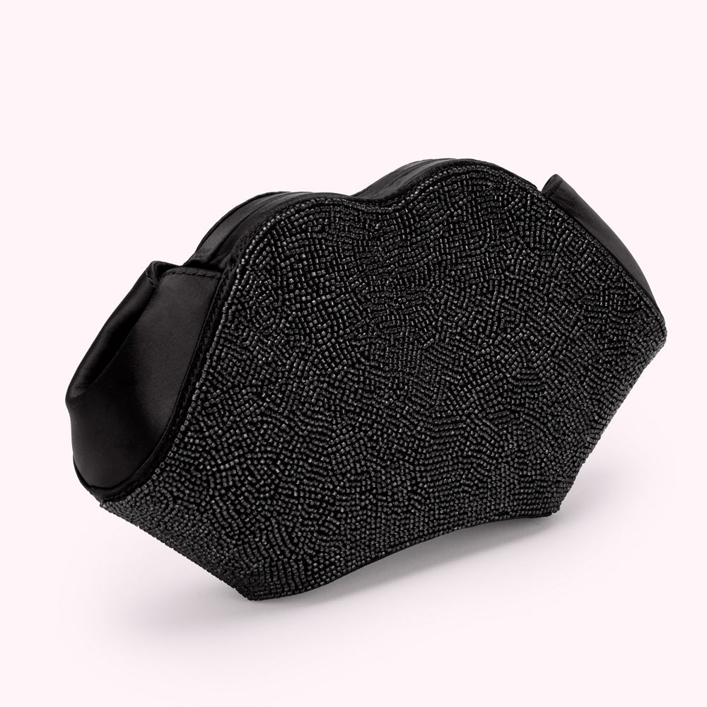 Black beaded lip-shaped clutch bag on a white background.
