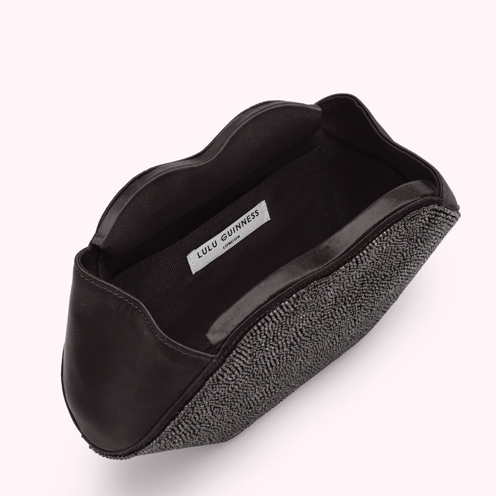 Open black Lulu Guinness lip-shaped clutch embellished with grey beads.

