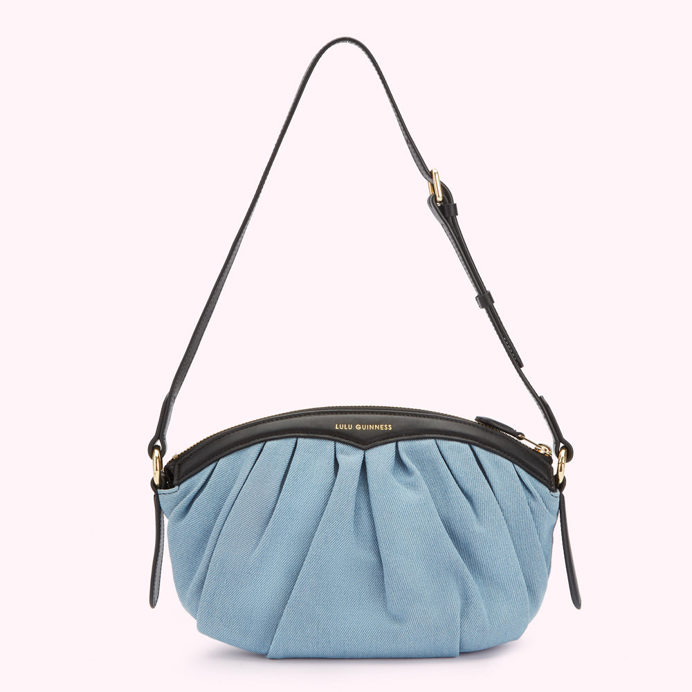 Light blue denim Lulu Guinness shoulder bag with black leather trim and gold hardware.
