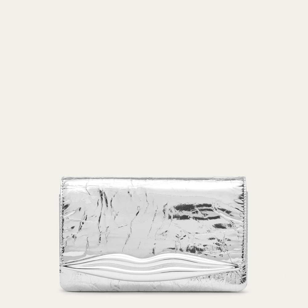 A metallic silver clutch bag with a textured, crinkled finish and a lip design along the bottom front, shown against a solid off-white background.