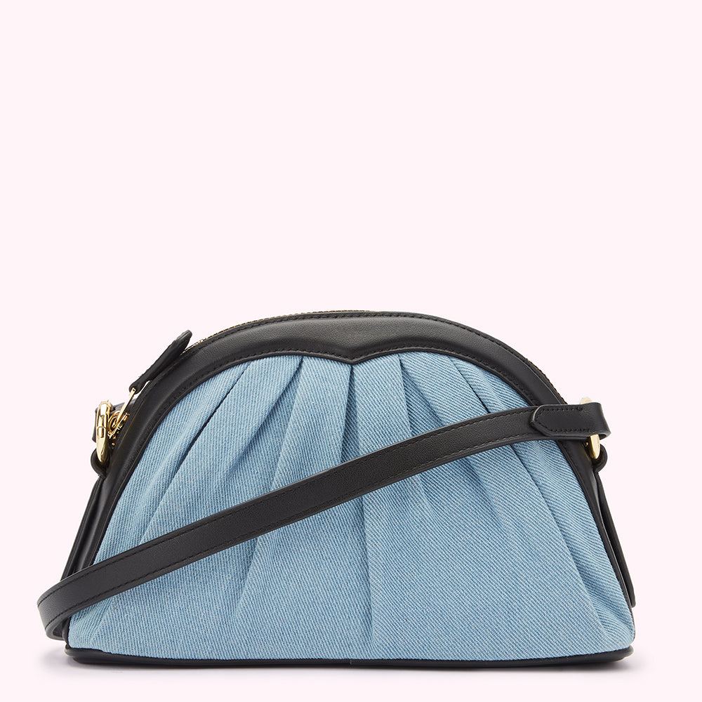 Light blue denim crossbody bag with black leather trim and strap.
