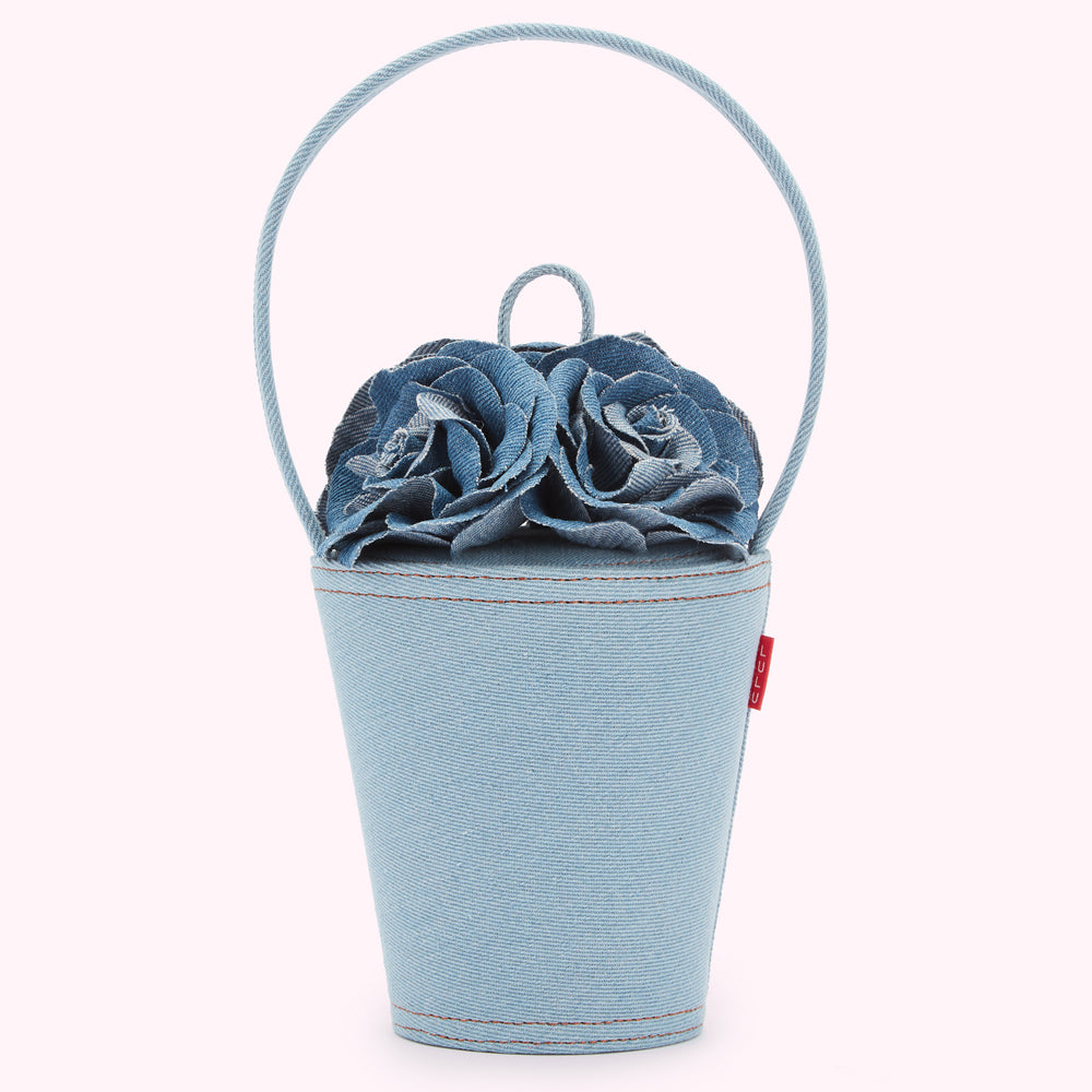 Light blue denim bucket bag with two denim roses on top.
