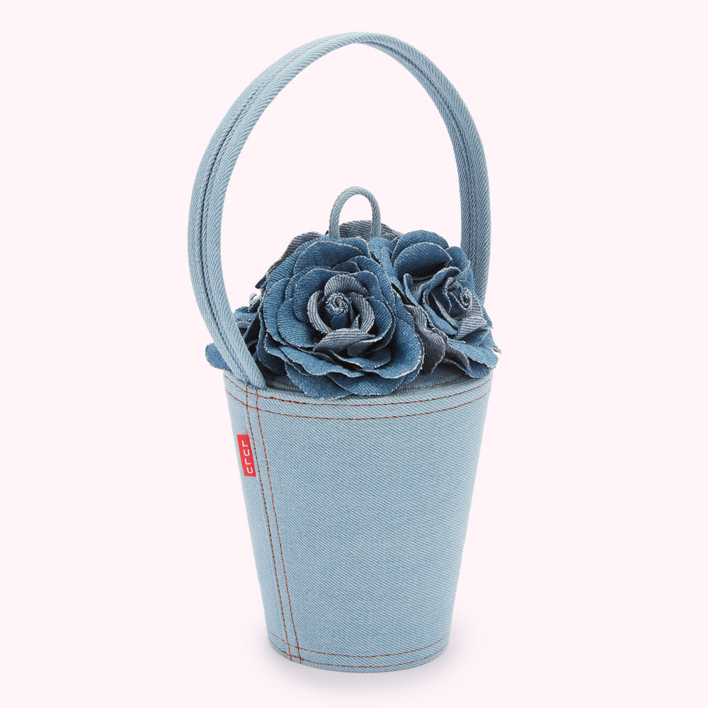 Light blue denim bucket bag with a top handle and three denim roses on top.