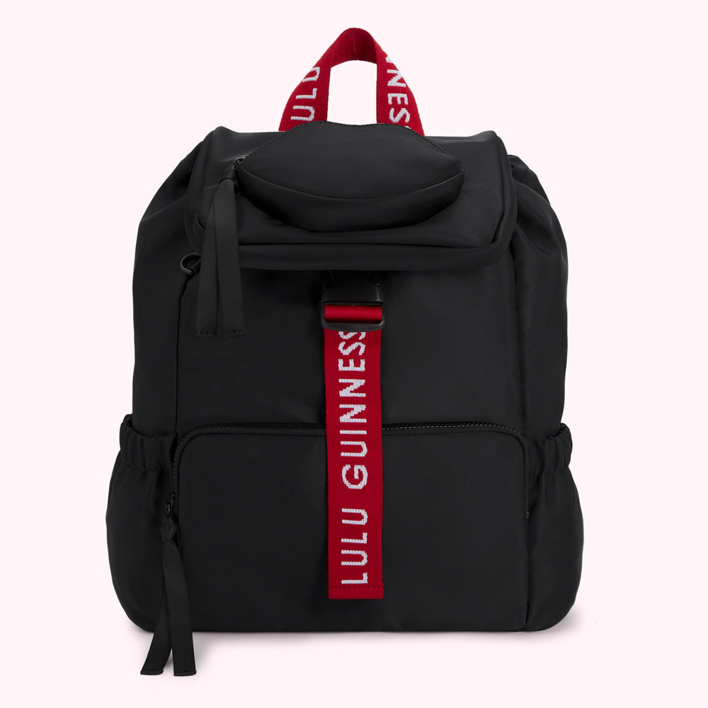 Black Lulu Guinness backpack with red straps and logo.