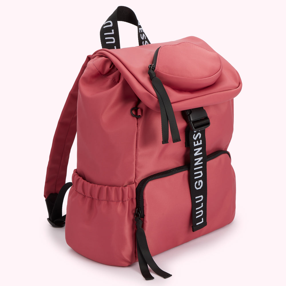 Dusty rose pink Lulu Guinness backpack with black straps and zippers.