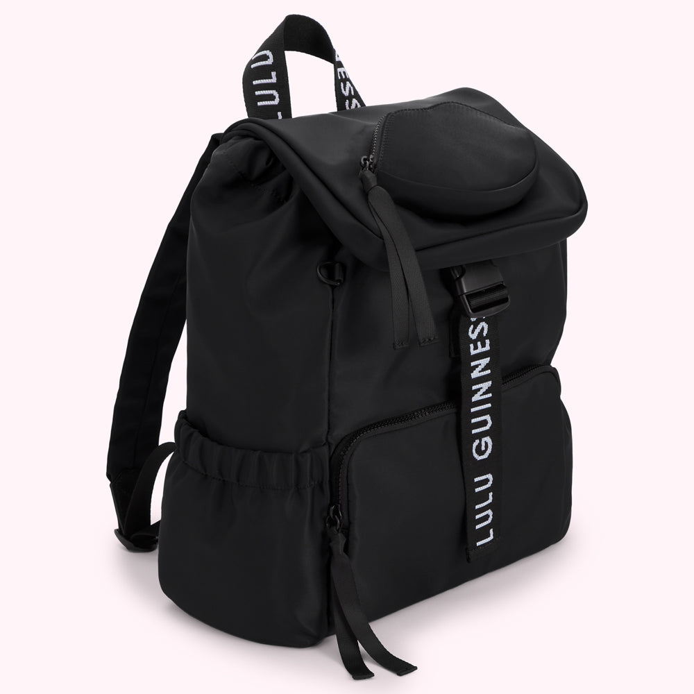 Black Lulu Guinness backpack with a flap top, drawstring detail and a branded strap.
