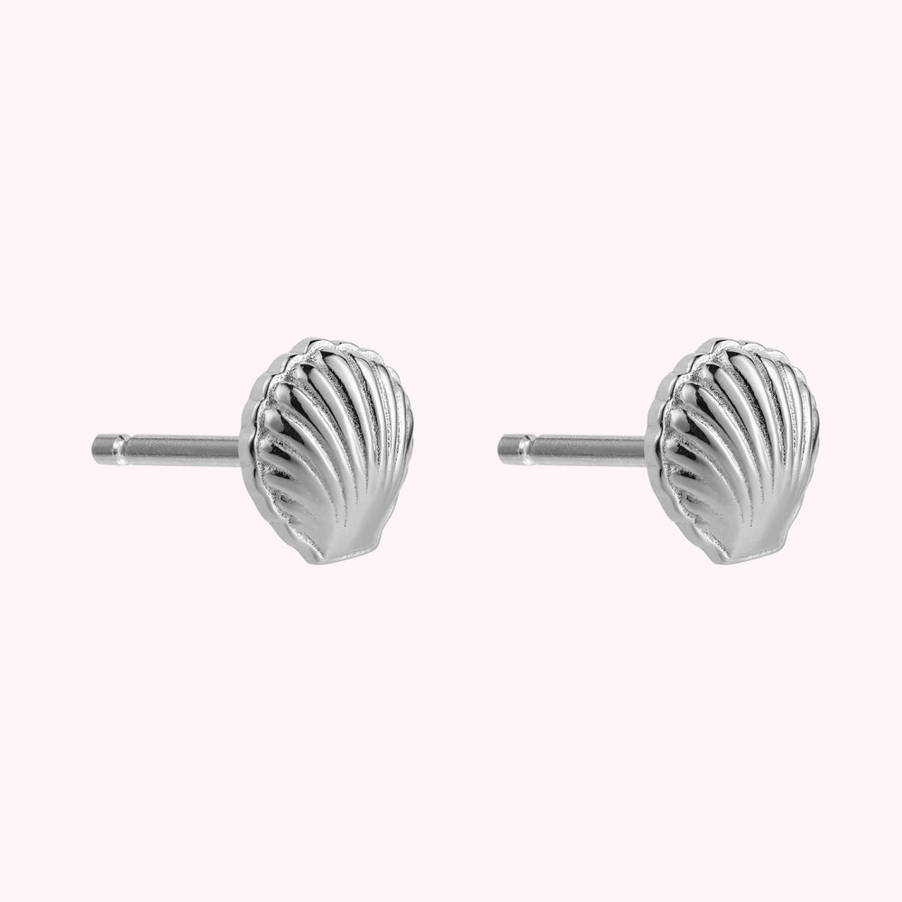 Side image of a pair of sterling silver shell shaped stud earrings.
