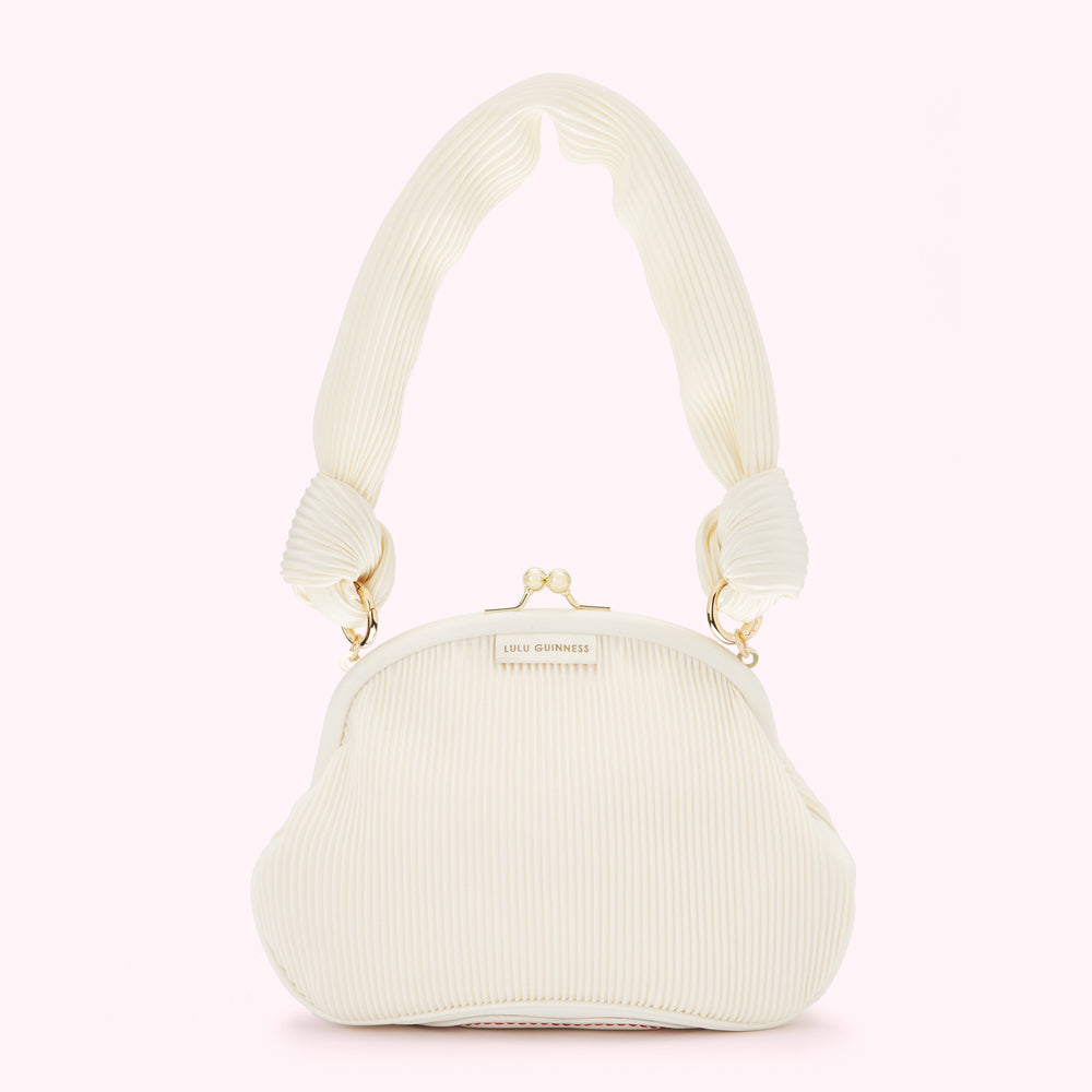 Off-white pleated Lulu Guinness handbag with knotted handles and gold clasp.
