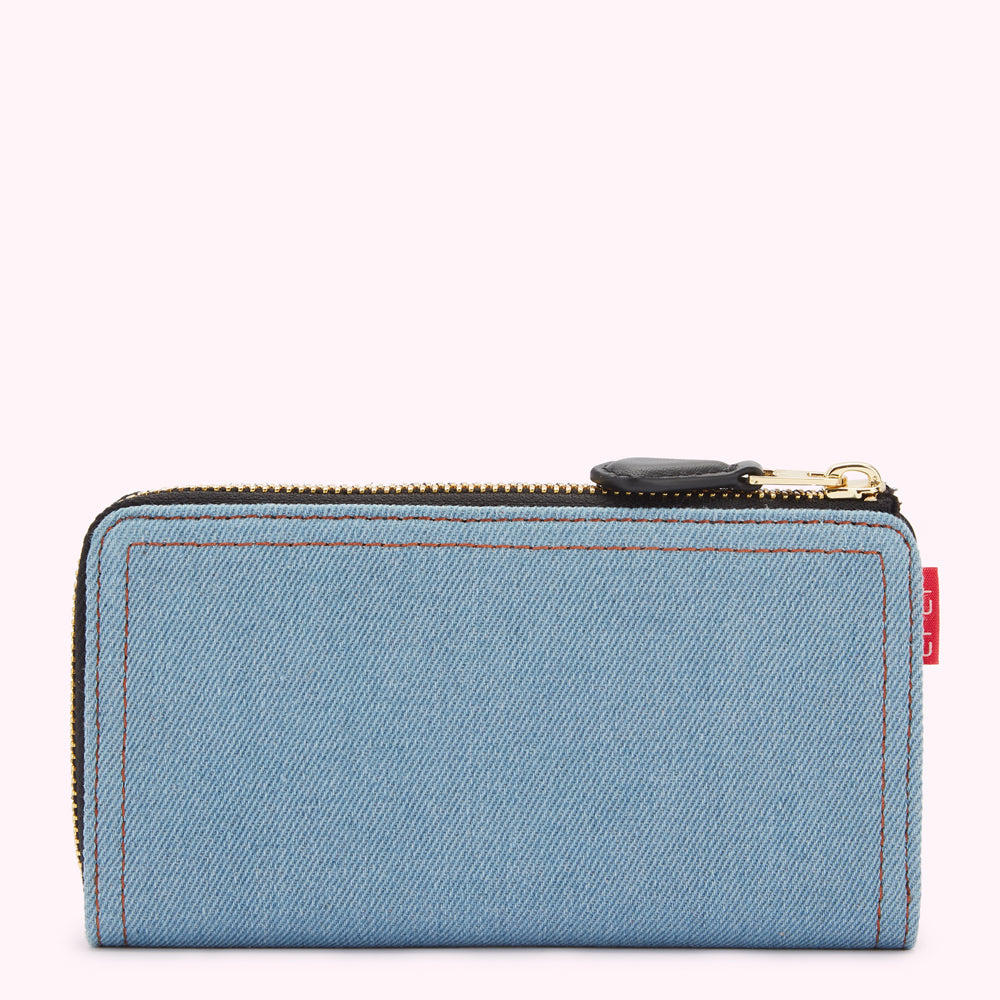 Light blue denim zip-around wallet with black zipper and red label.
