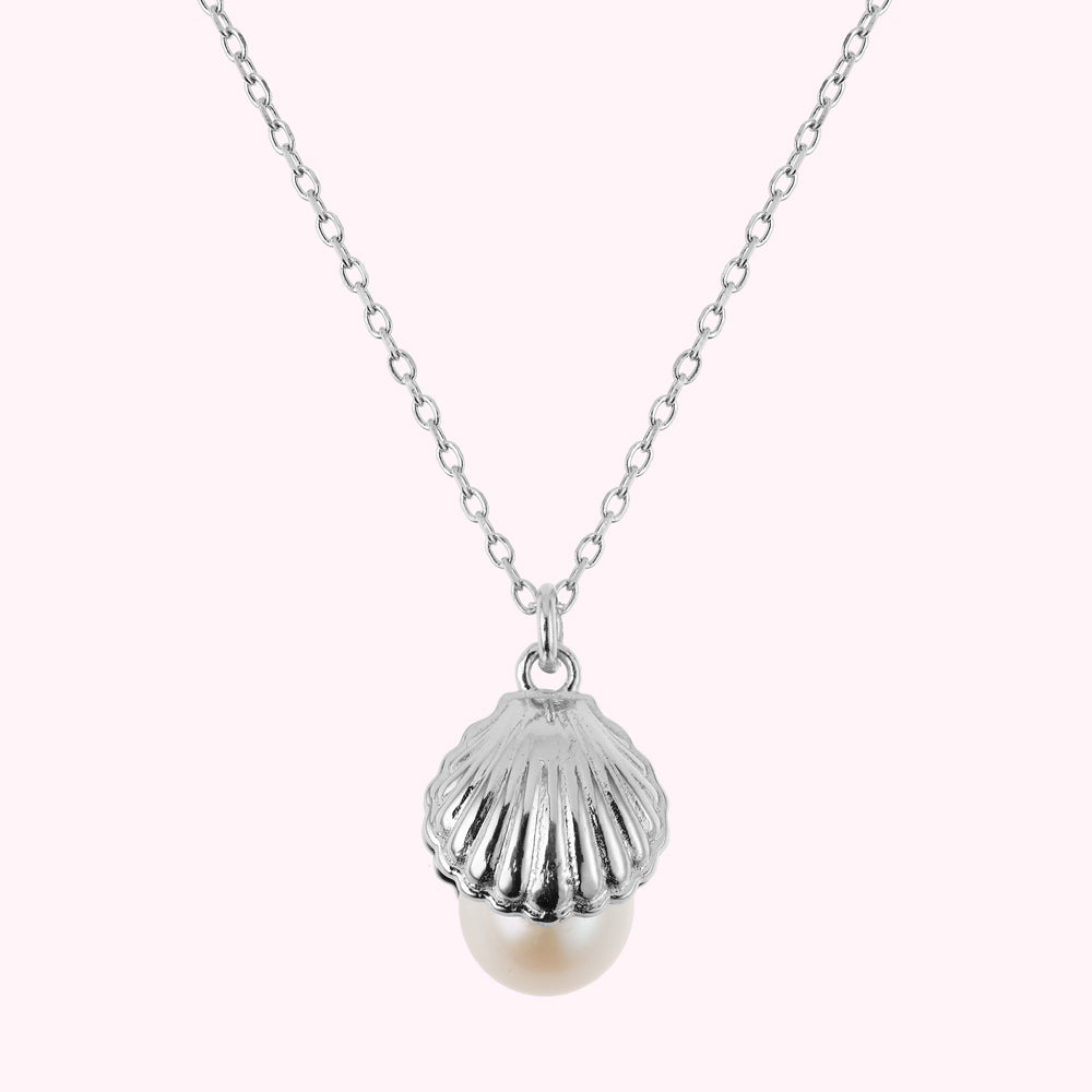 Close up image of a sterling silver shell pendant with a freshwater pearl.