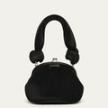 Black pleated satin handbag with knotted handles on a light gray background