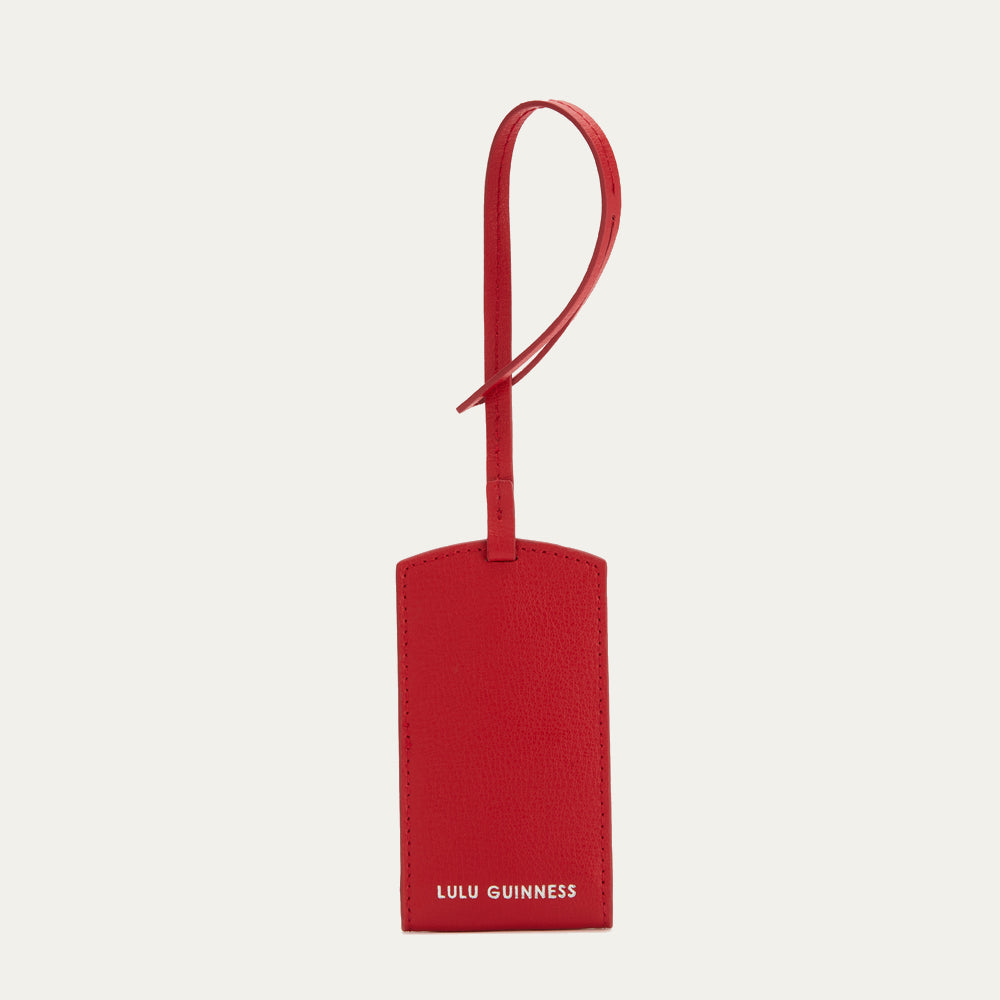 Red leather luggage tag with Lulu Guinness logo.