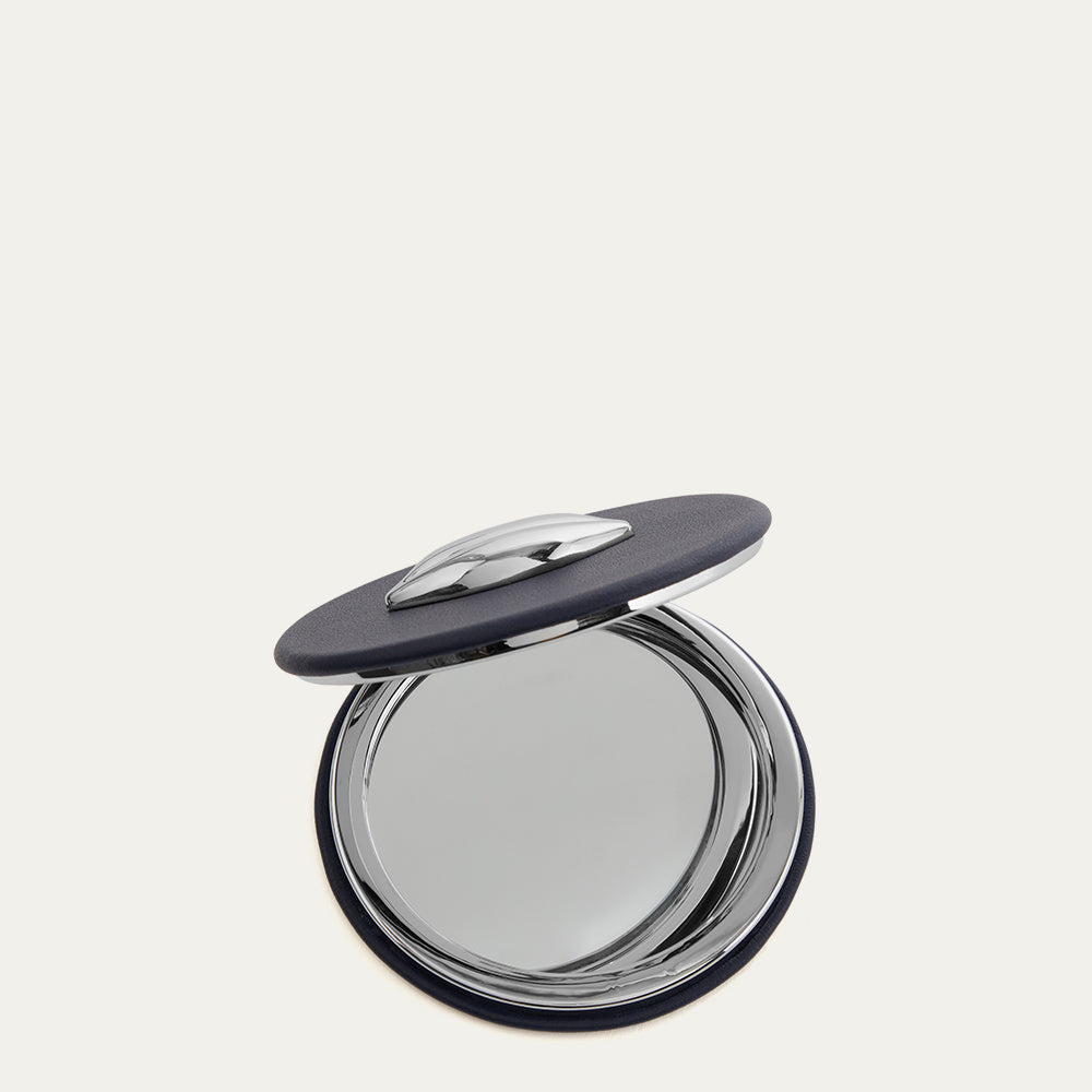 Navy compact mirror open on a white background