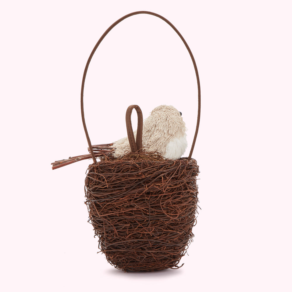 Brown Lulu Guinness bird nest handbag with a beige bird in a brown twig nest with a brown handle.