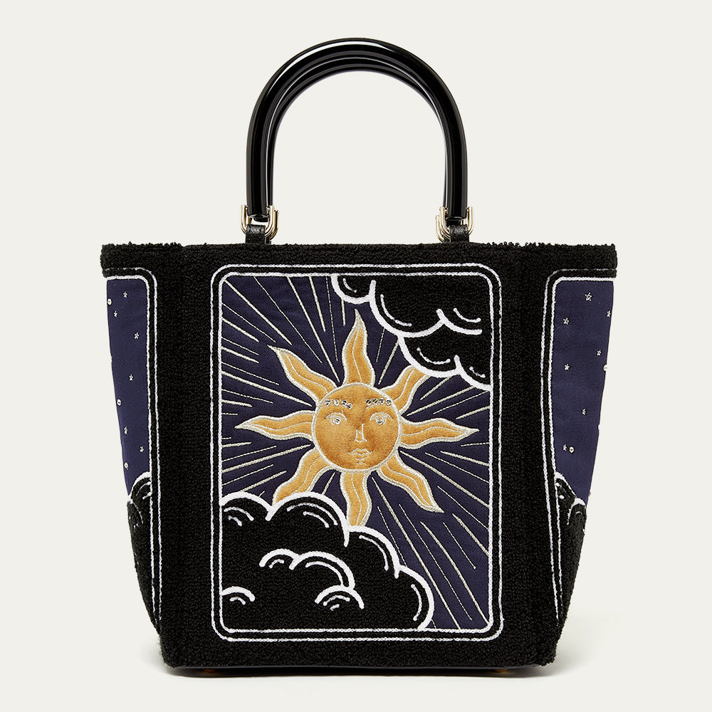 Handbag with sun and moon design on a white background