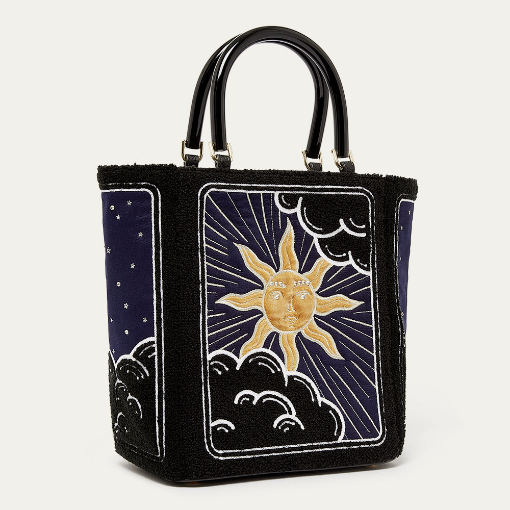 Handbag with sun and moon design on a white background