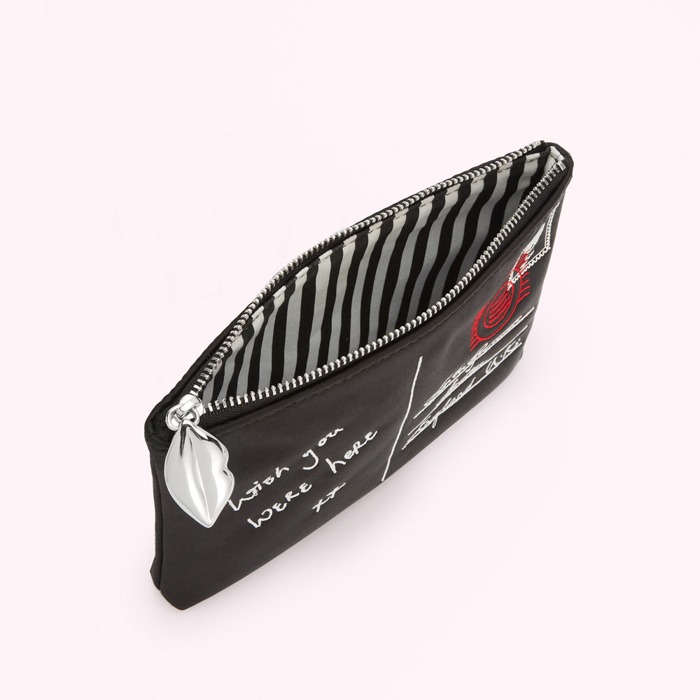Black satin pouch with a silver zipper and embroidered postcard design. The text on the pouch reads "Wish you were here". The inside lining is black and white striped.
