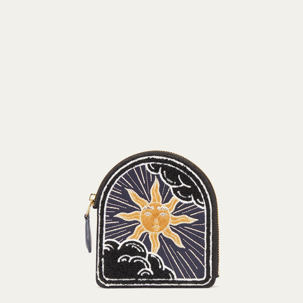 Small coin purse with sun and cloud design on a white background
