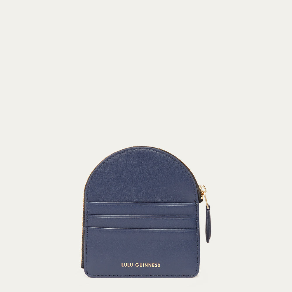 Navy blue coin purse with gold zipper on a light gray background